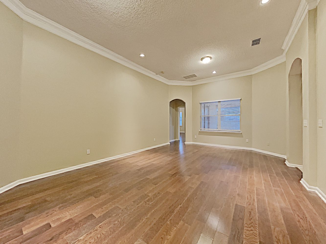 Beautiful living space with wood-style flooring at Invitation Homes Jacksonville.