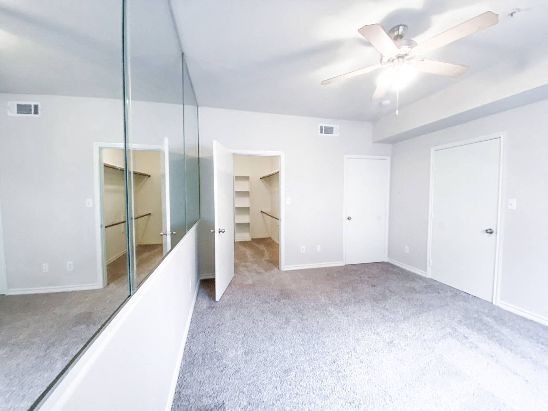 Spacious bedroom with huge mirror