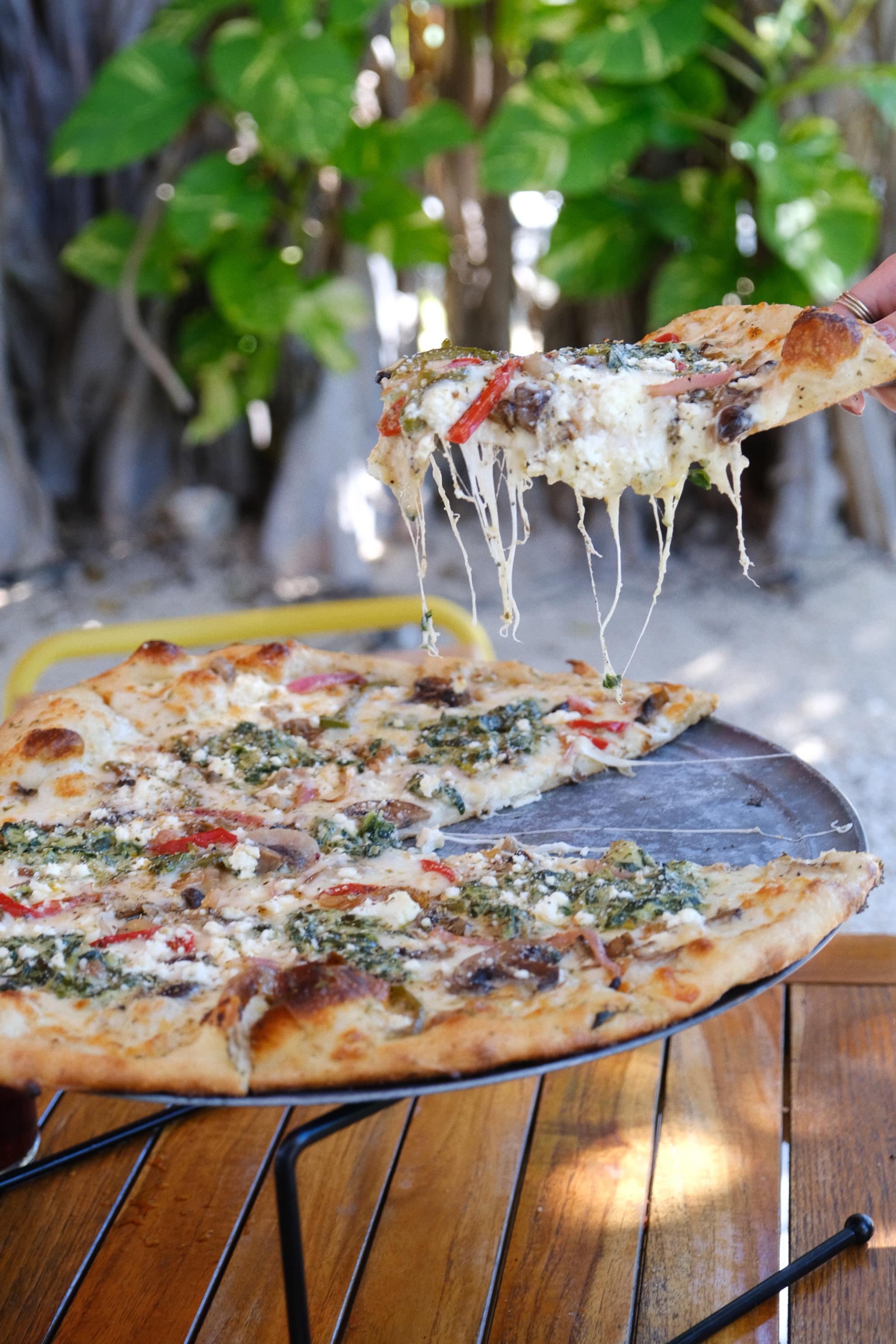 Garden Pizza White Sauce, Mozzarella, Bell Pepper, Red Onion, Spinach, Artichoke, Mushroom, Feta, Basil Pesto