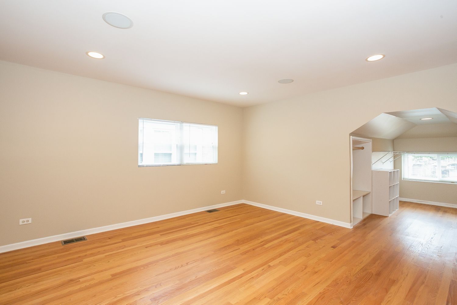 Living area with natural light and hardwood floors at Invitation Homes Chicago.