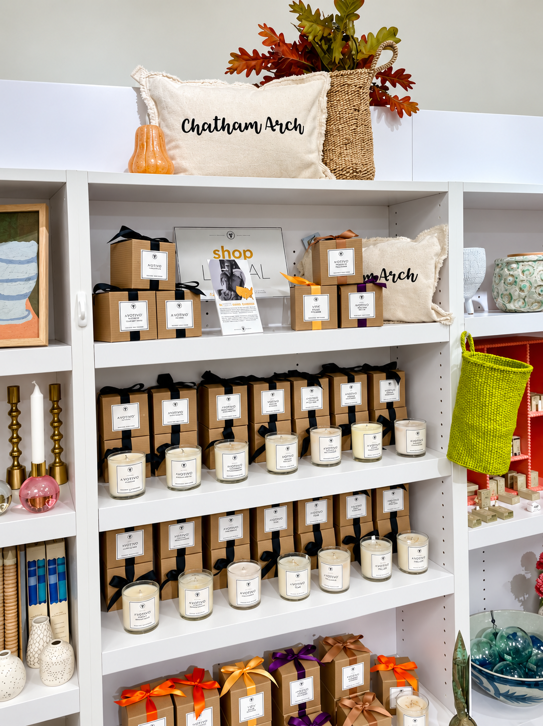 Decorate’s candle display features elegant jar candles, ribbon-wrapped gift boxes, decorative candle 
