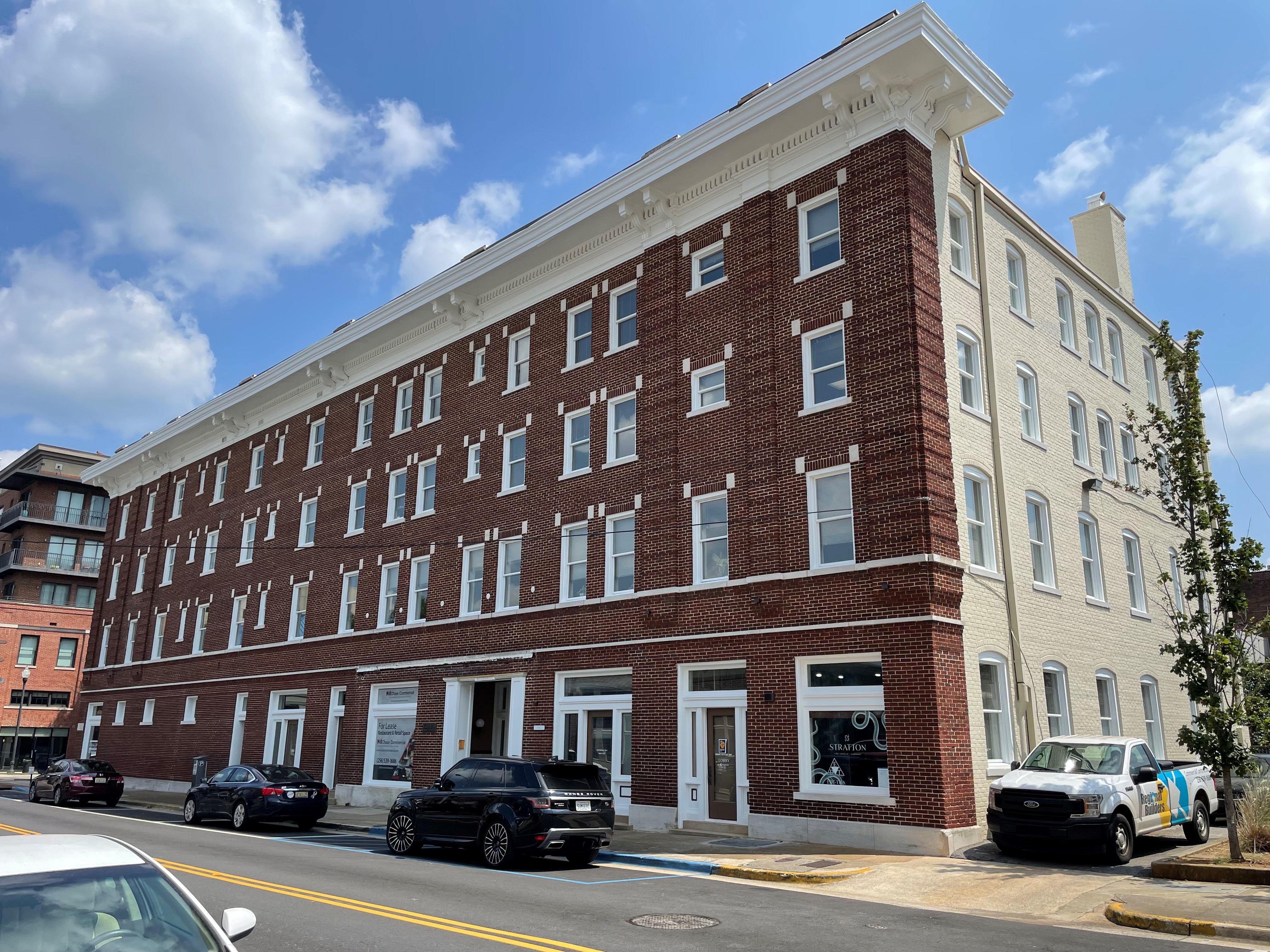 front of a 4-story brick building for sale with NAI Commercial Real Estate