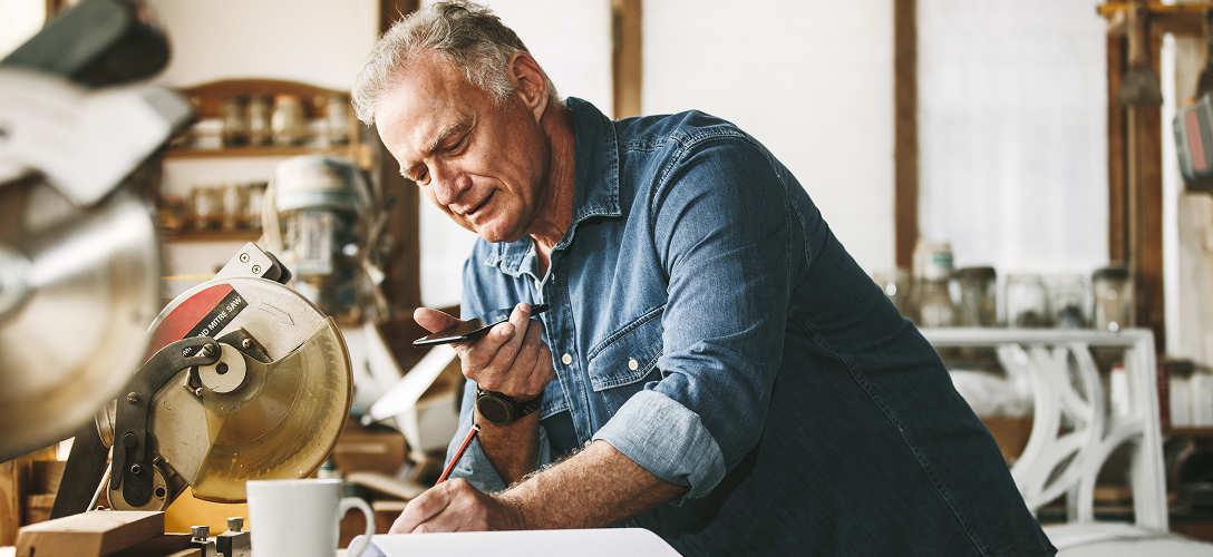 A person on the phone in a workshop.