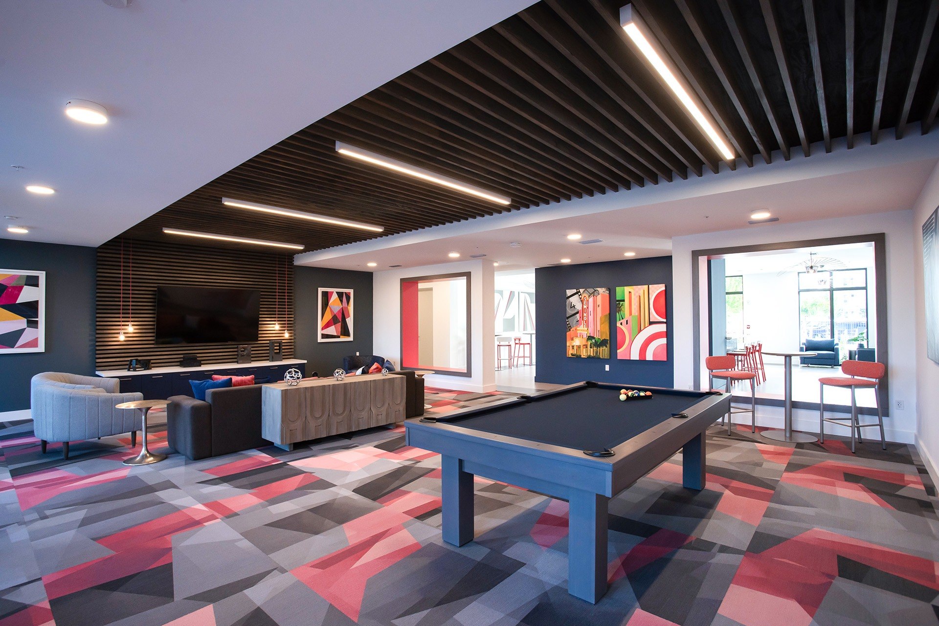 Resident clubhouse with pool table and lounge seating