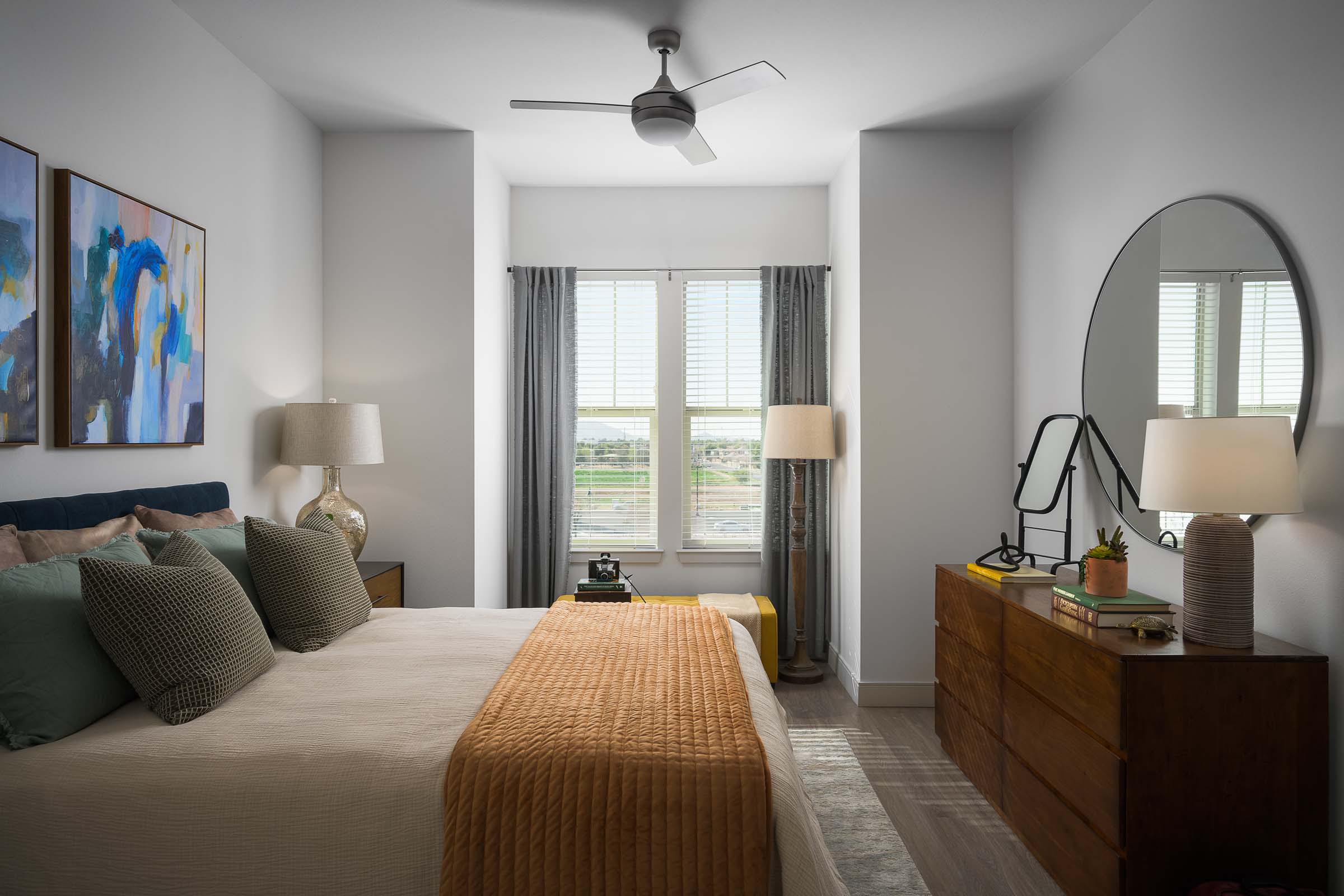 Bedroom with large window and ceiling fan at Camden Gilbert apartment homes in Gilbert, AZ