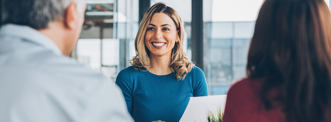 An advisor smiling at her clients.