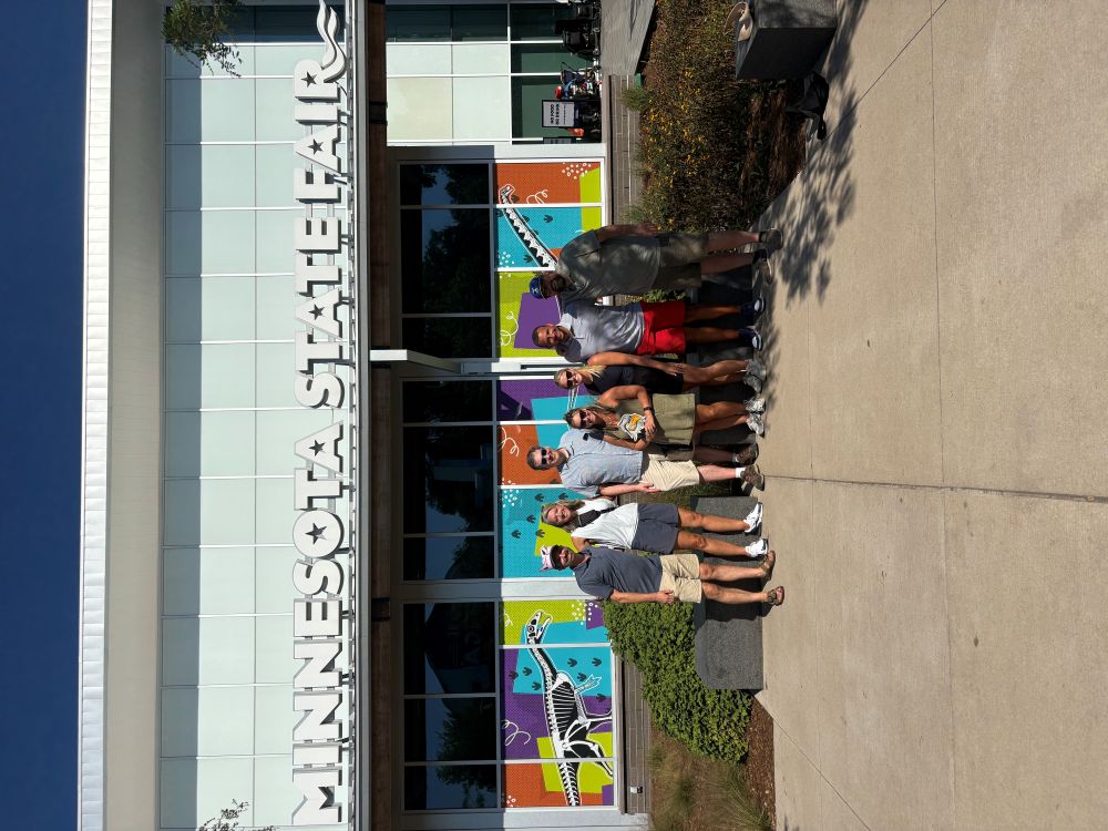 The Clarity Financial team posing together outside during their annual team outing at the Minnesota State Fairgrounds in Falcon Heights/St. Paul, MN.