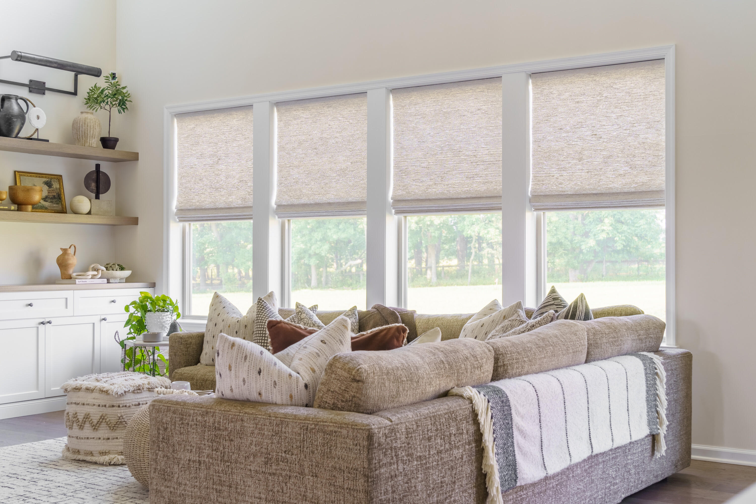 These woven wood shades add a neutral and soft ambiance to this living room. They are available in a wide range of colors and hues, too!