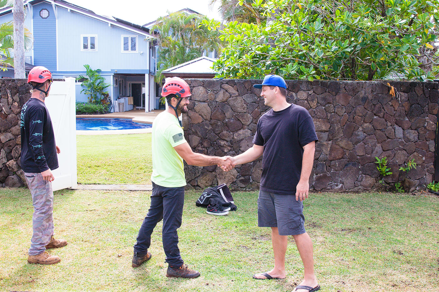 In Oahu, Hawaii, a tree service technician uses a chipper to recycle tree branches, promoting environmental sustainability.