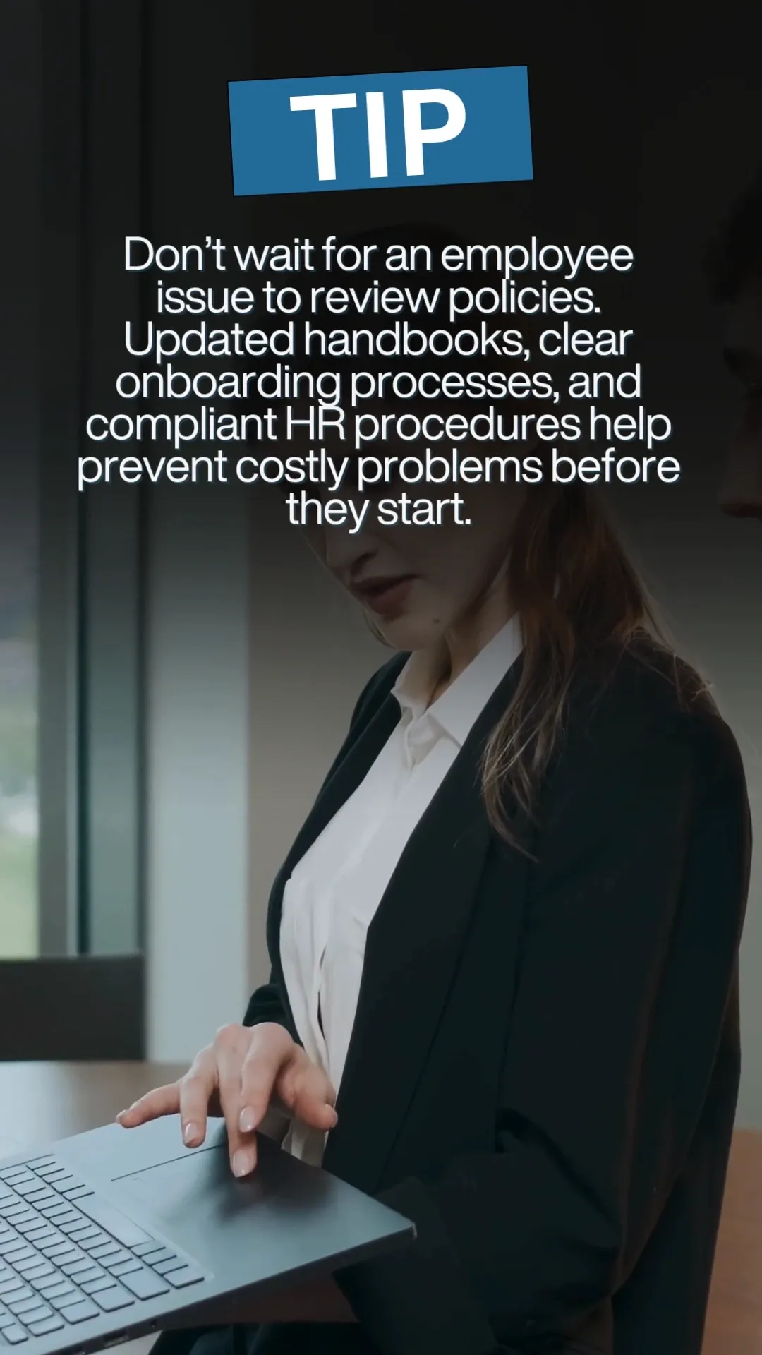A close-up shot shows a woman in a black blazer and white shirt holding a laptop. Text overlay reads "TIP" in large white letters within a blue rectangle. Below the "TIP" text, there is a paragraph of advice about proactively reviewing HR policies. The background suggests an office environment with muted colors and natural light.