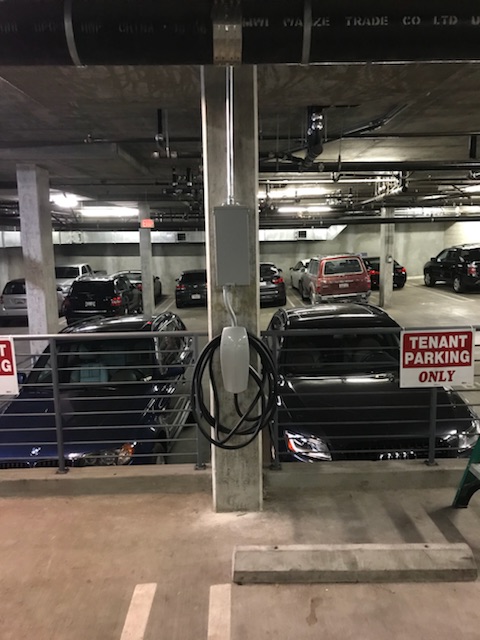 Tesla EV charger in a commercial garage
