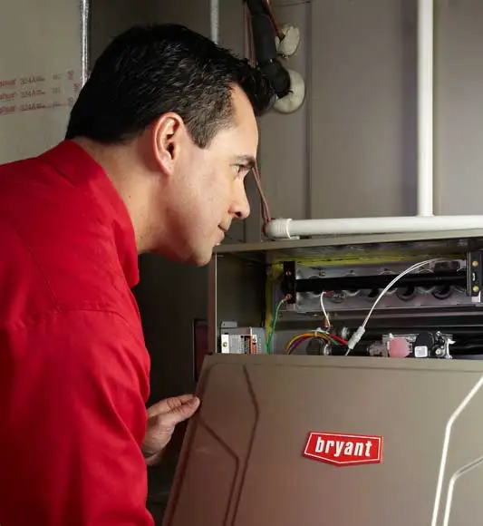 Bryant tech working on heating unit Port Richey, FL
