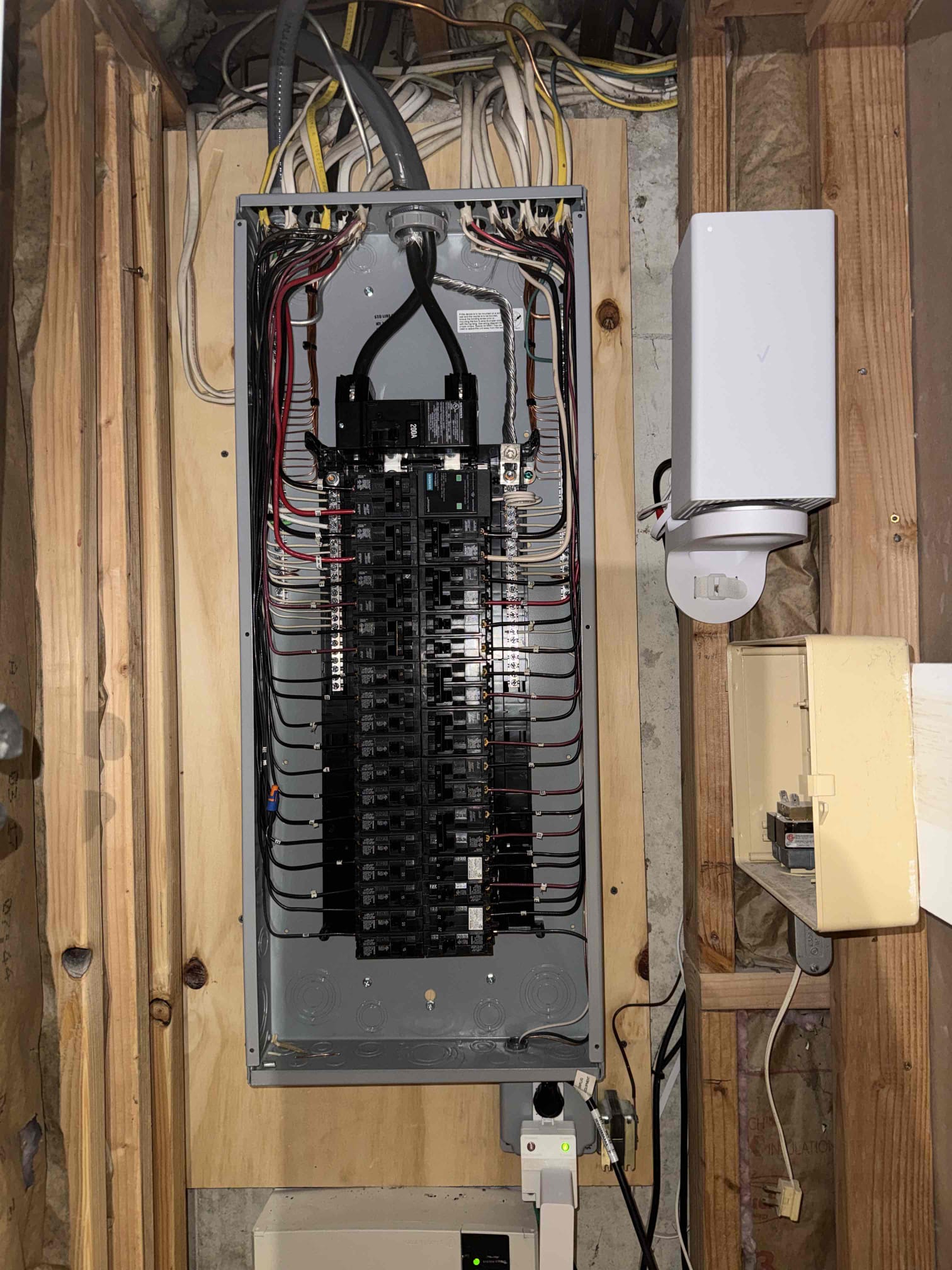 Thomas Edison Electric completed a full 200-amp breaker panel upgrade in a North Wales, PA basement. The fully loaded panel features neatly dressed wiring throughout, with a whole-home surge protector mounted alongside the enclosure for added protection.