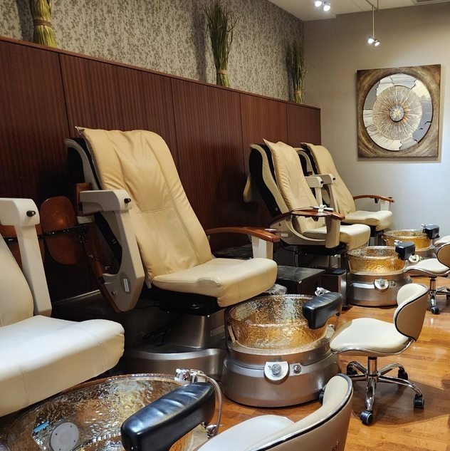 Pedicure stations with spa chairs in a calm, upscale setting