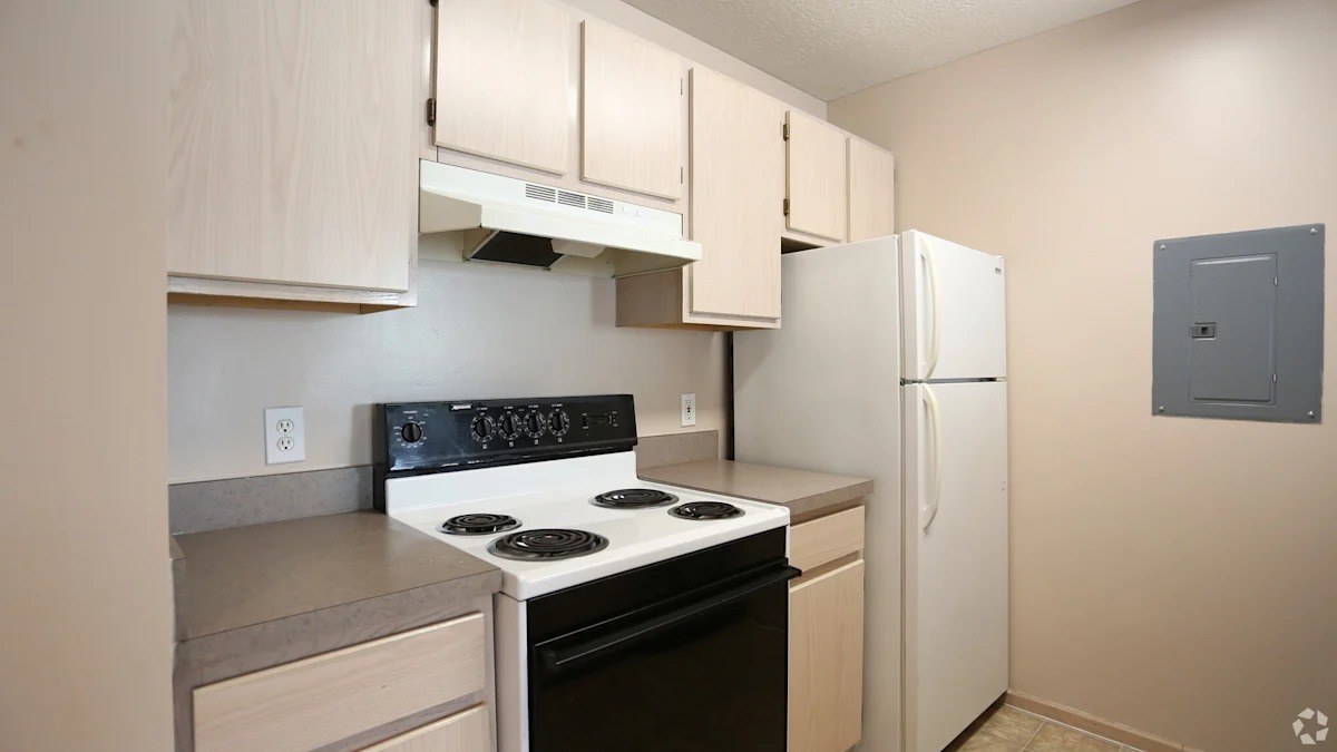 A kitchen with a stove, oven, and refrigerator.