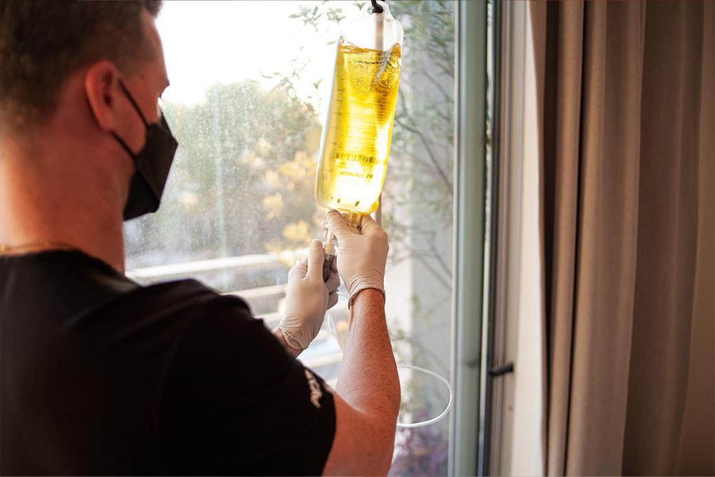 Mobile IV nurse preparing a hydration and vitamin infusion drip in Los Angeles