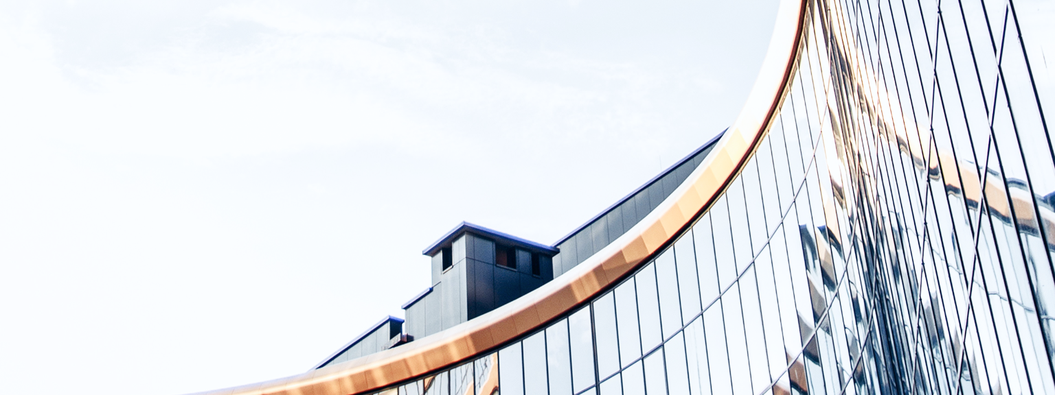 Close-up architecture shot of a building with a curved glass façade.
