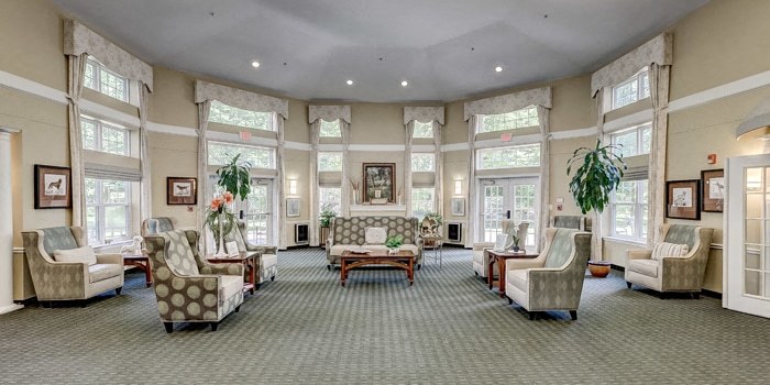a large living room filled with furniture and large windows