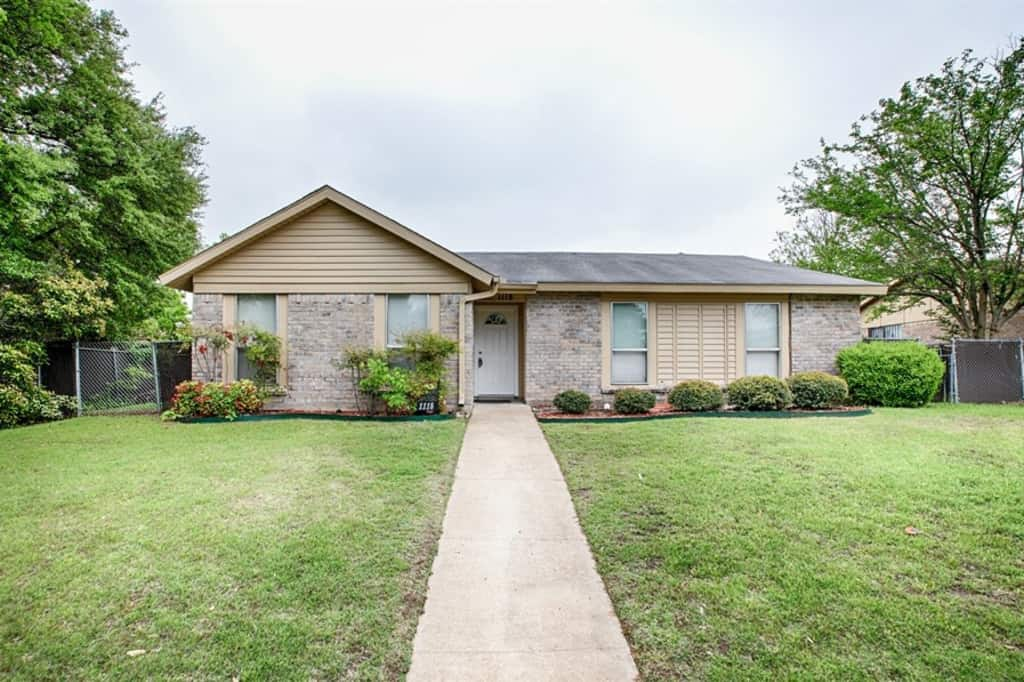 Front of home with long sidewalk leading up to front  door at Invitation Homes Dallas.