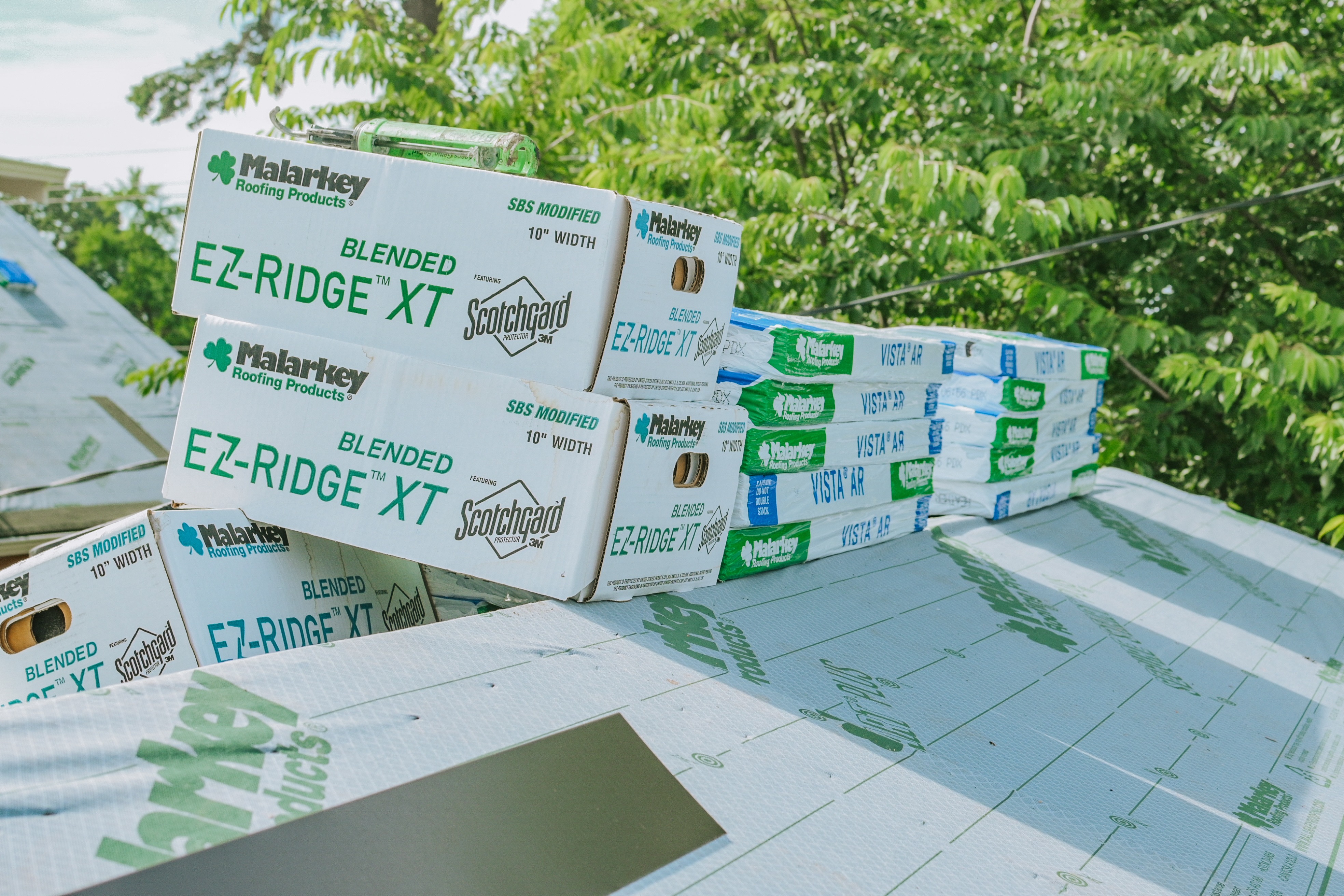 Residential roof prepared with synthetic underlayment before shingle installation. 