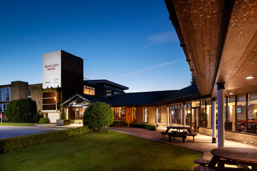 Exterior shot of Mercure Wetherby Hotel at dusk, patio area light up, lawn. Mercure Wetherby Hotel Wetherby 01937 862918