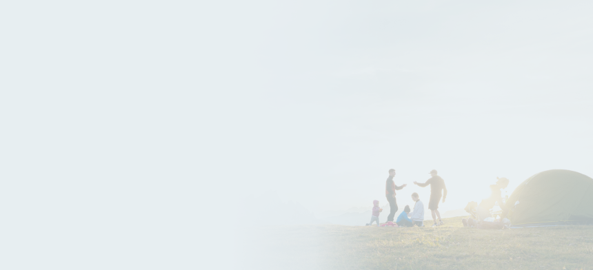 Two young families setting up camp together on the side of a mountain.