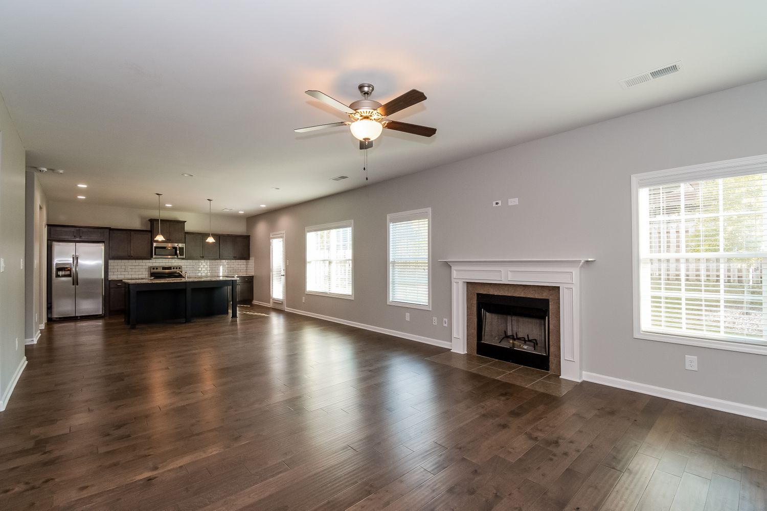 Spacious family room with easy kitchen access at Invitation Homes Atlanta.