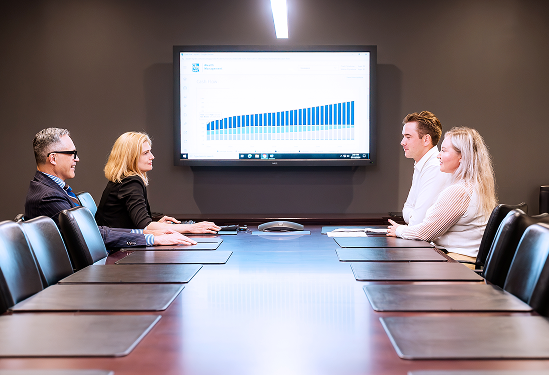 Four members of the Rae Family Wealth team in a boardroom.