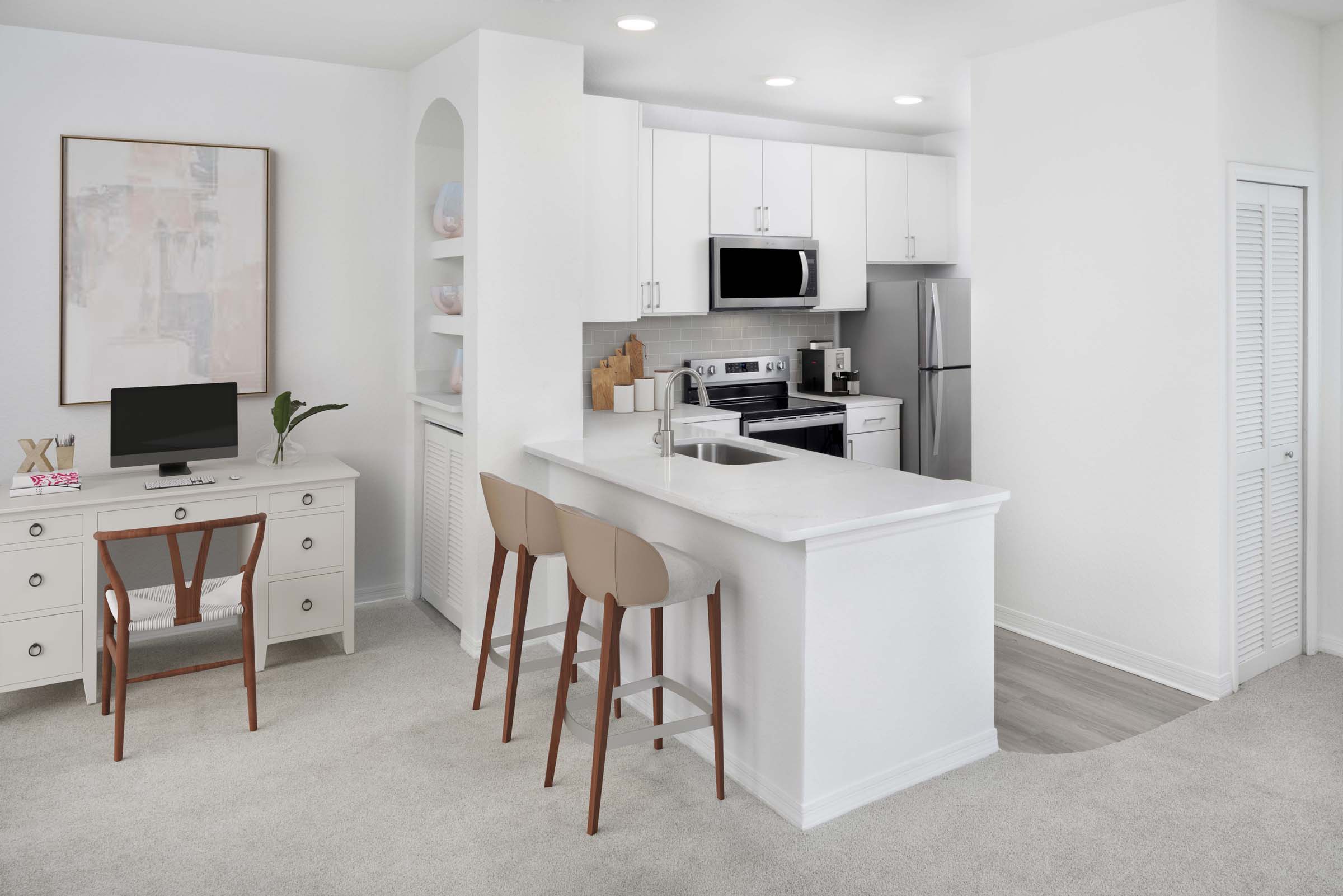Kitchen with white finishes and home office space at Camden World Gateway apartments in Orlando, FL