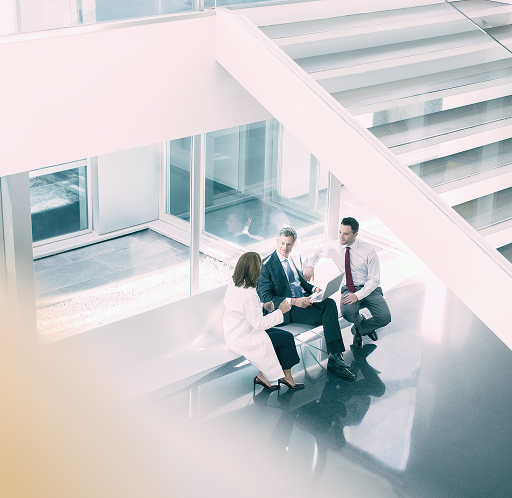 Three professionals meeting in an office.
