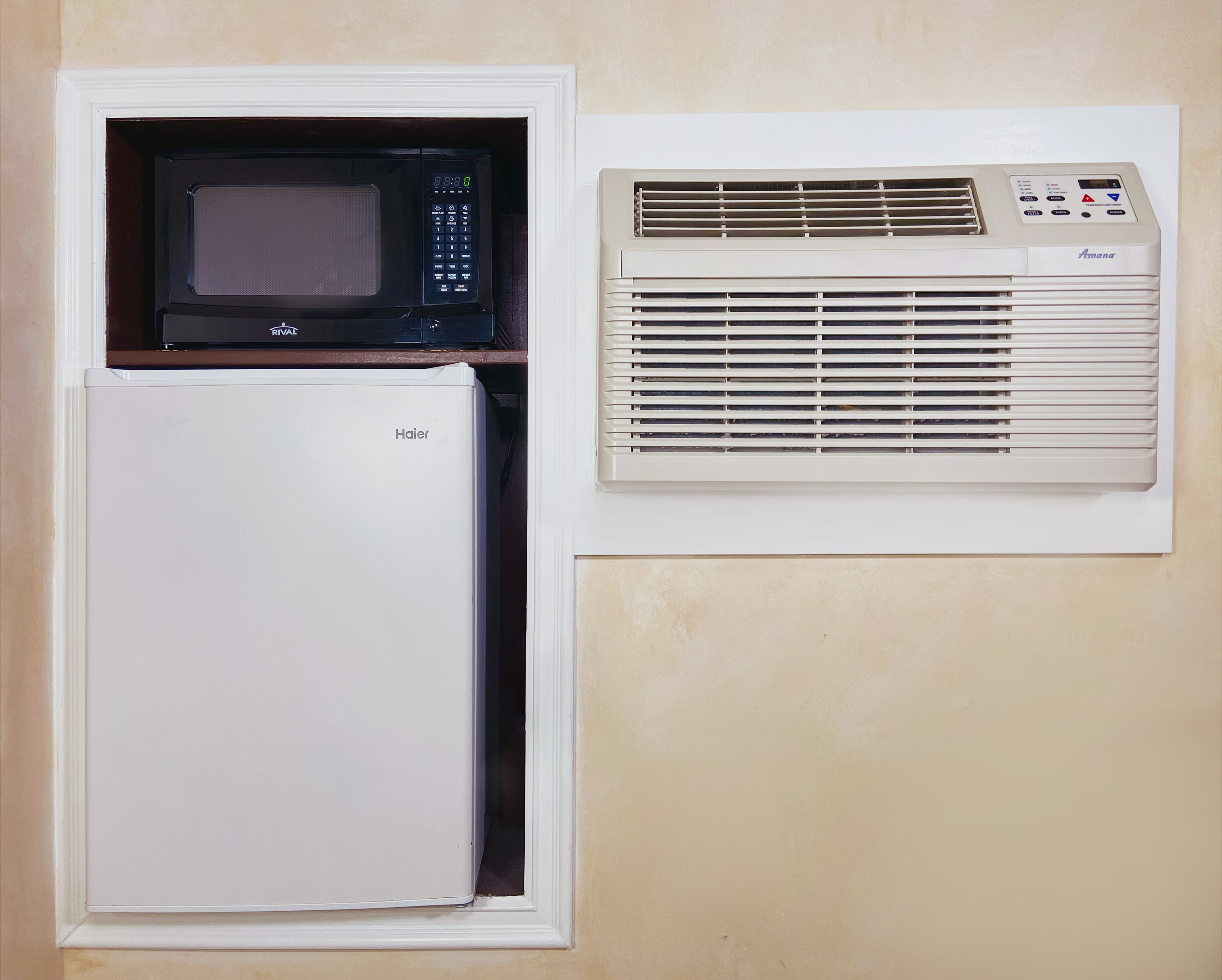 A microwave, a small fridge, and an AC unit