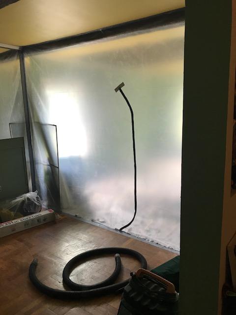 A containment is in place to stop the spread of mold spores during mold remediation.