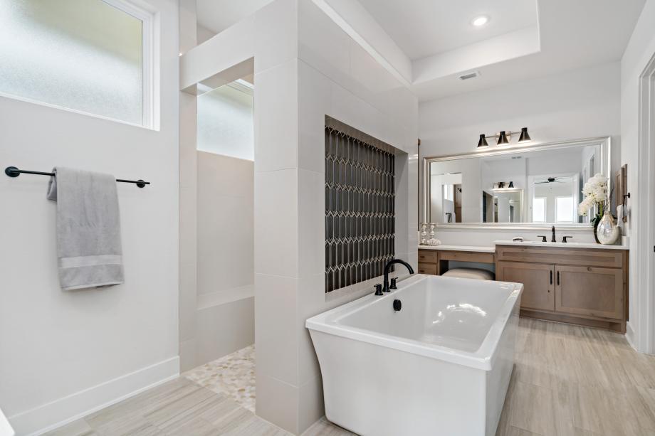 Lavish primary bathroom with walk-through shower and free-standing tub