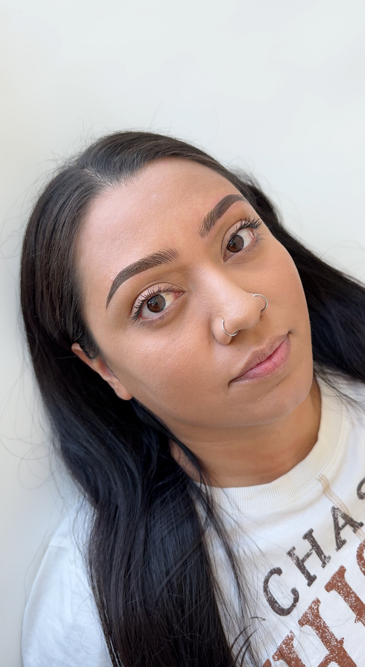 An image showing flawless combination brows in Riverton, Utah, with nano hair strokes at the front blending seamlessly into soft ombr&eacute; shading.