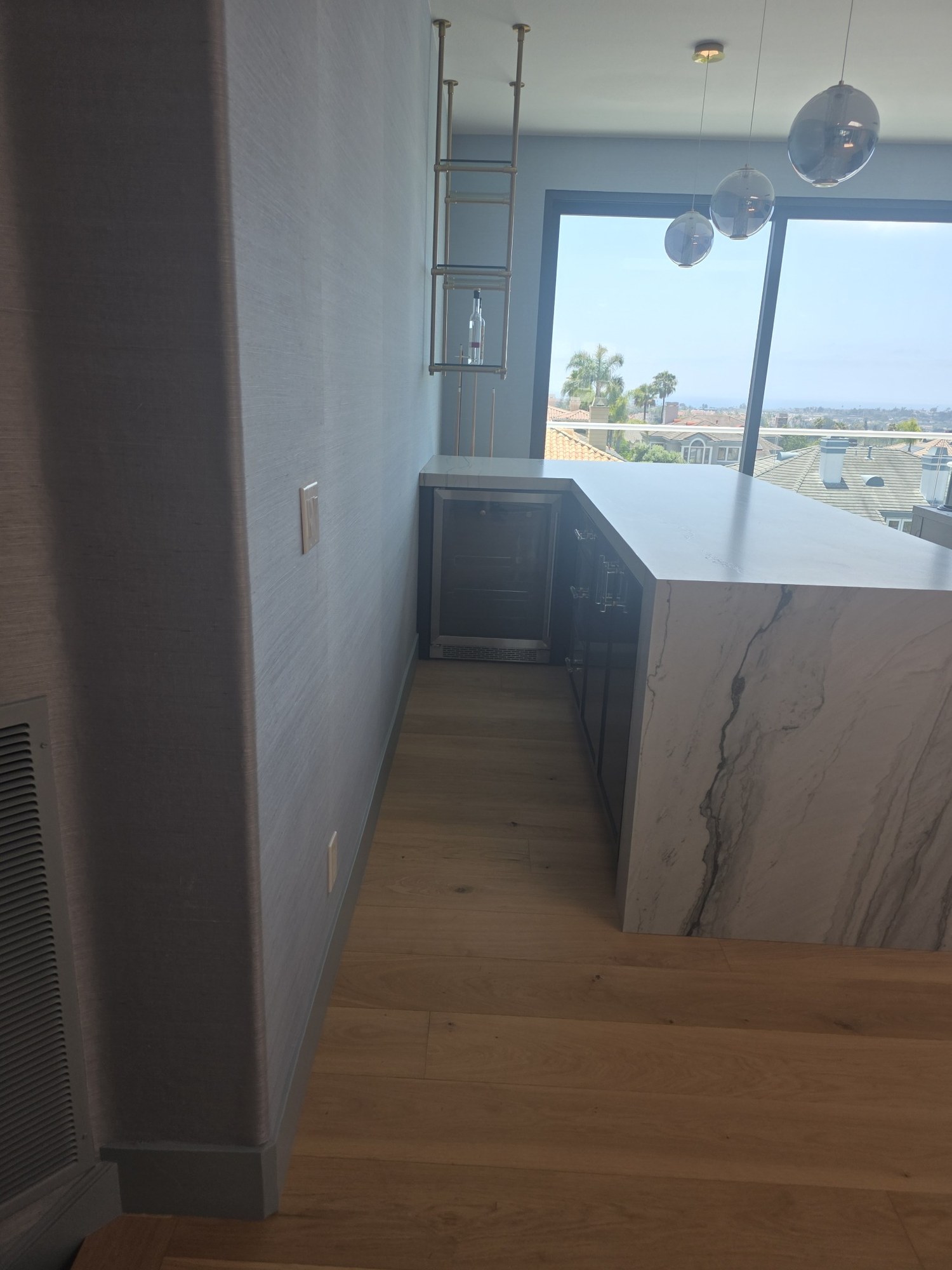 Remodeled interior with hardwood flooring, custom cabinetry, and waterfront views. 