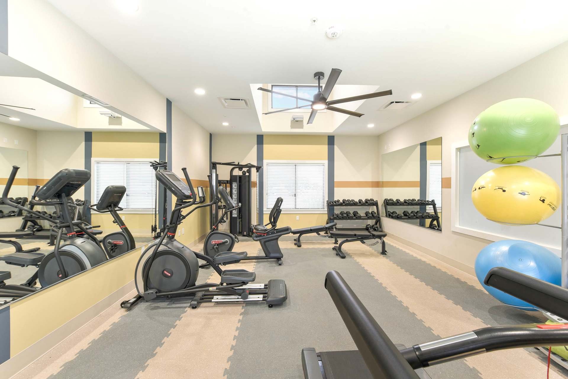 Fitness center with cardio equipment.