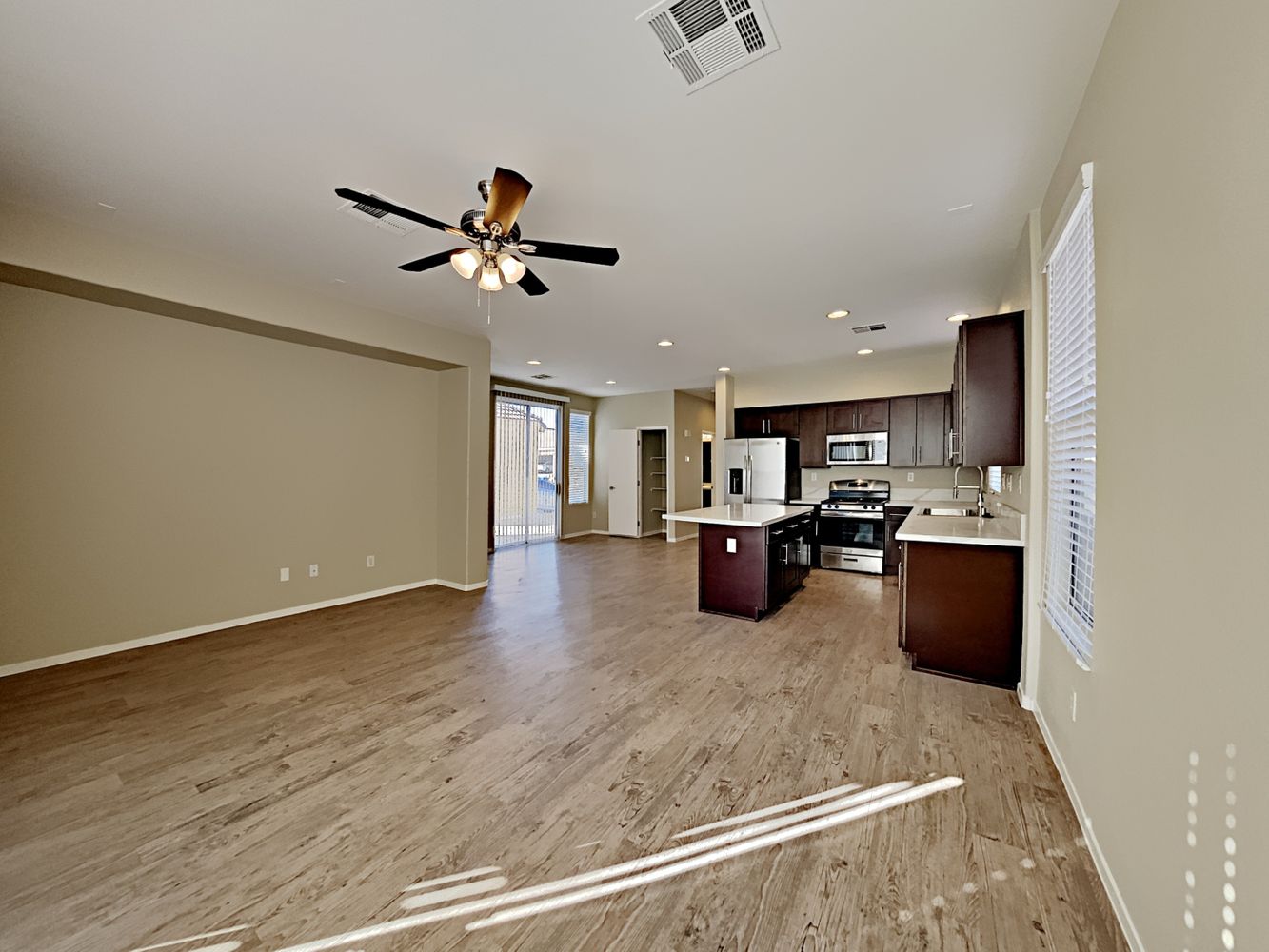 Spacious living area with luxury vinyl plank flooring at Invitation Homes Las Vegas.