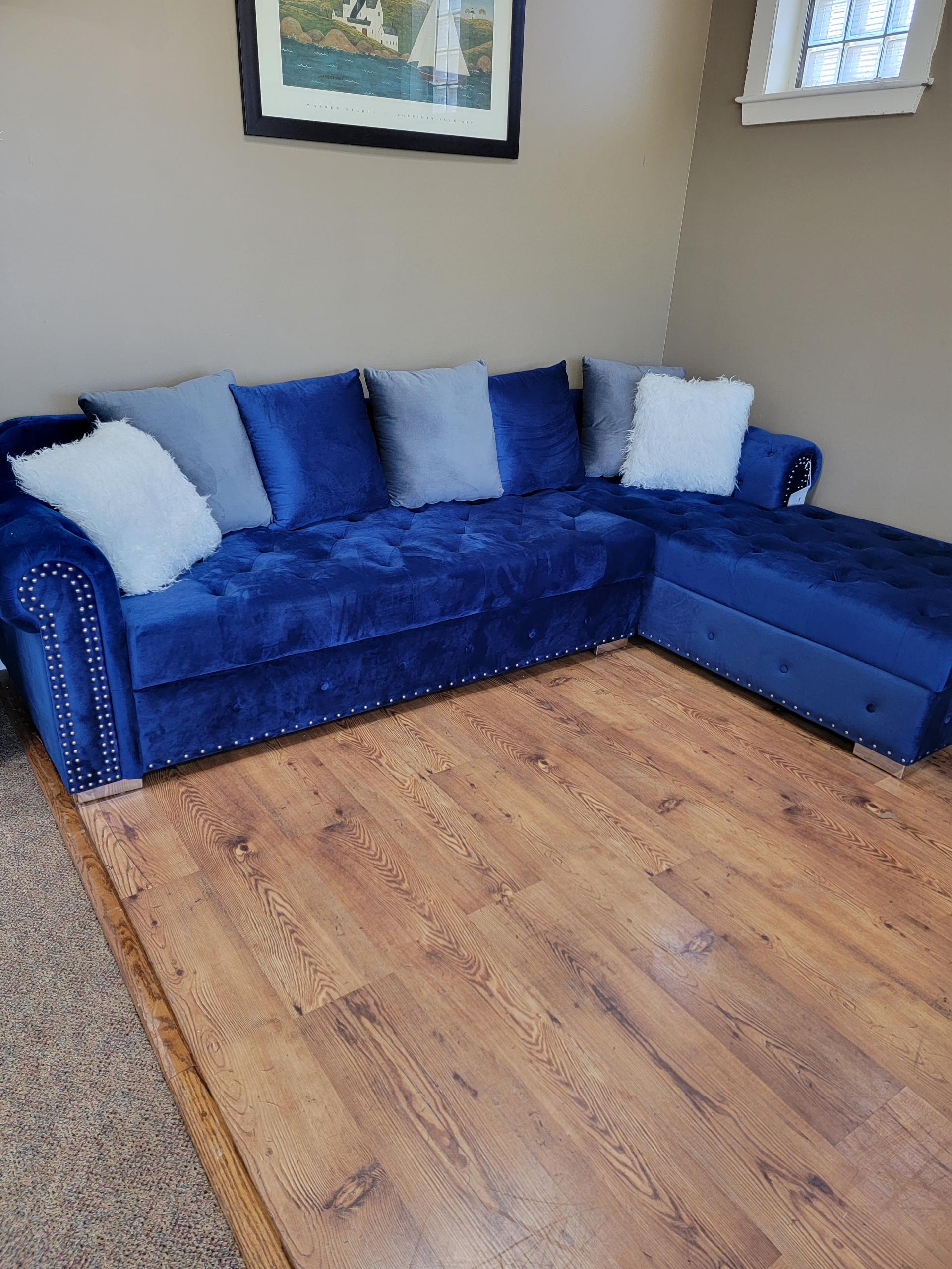 Plush blue sectional ready to make your living room that cozy corner.