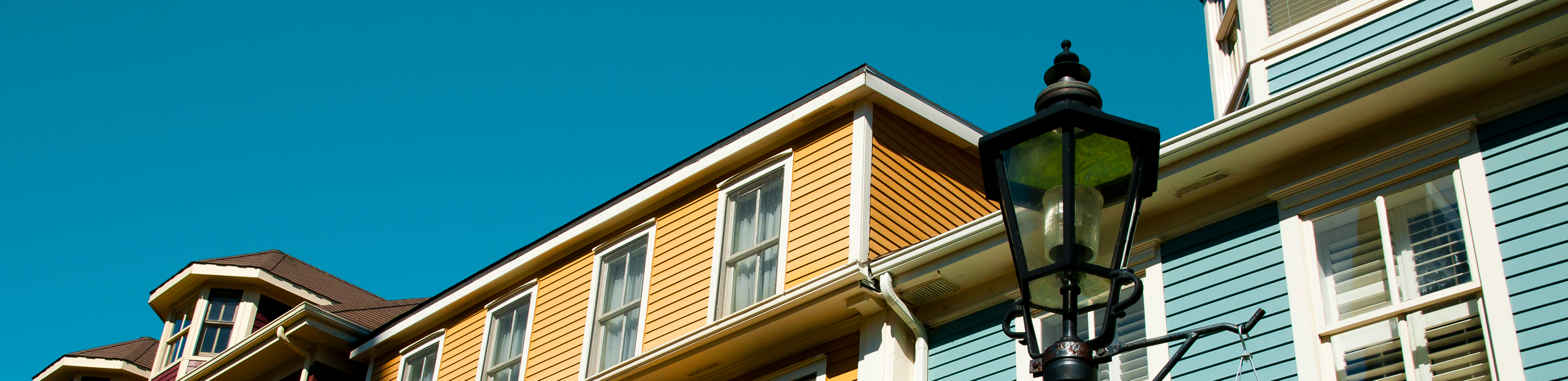 Close-up of a row of colourful Victorian clapboard houses.