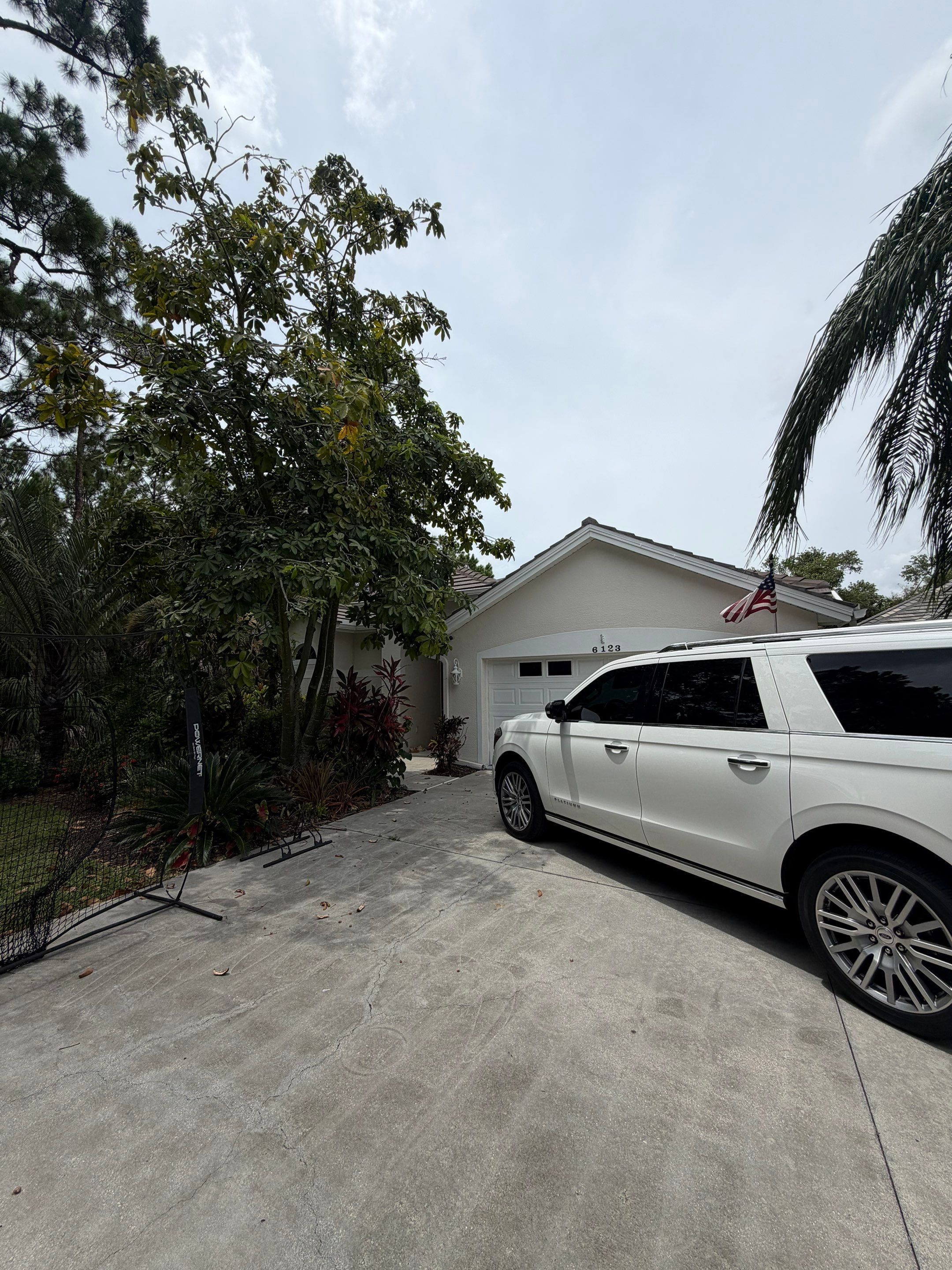 Roofing contractor’s service vehicle parked beside a residential property during an on-site roofing  