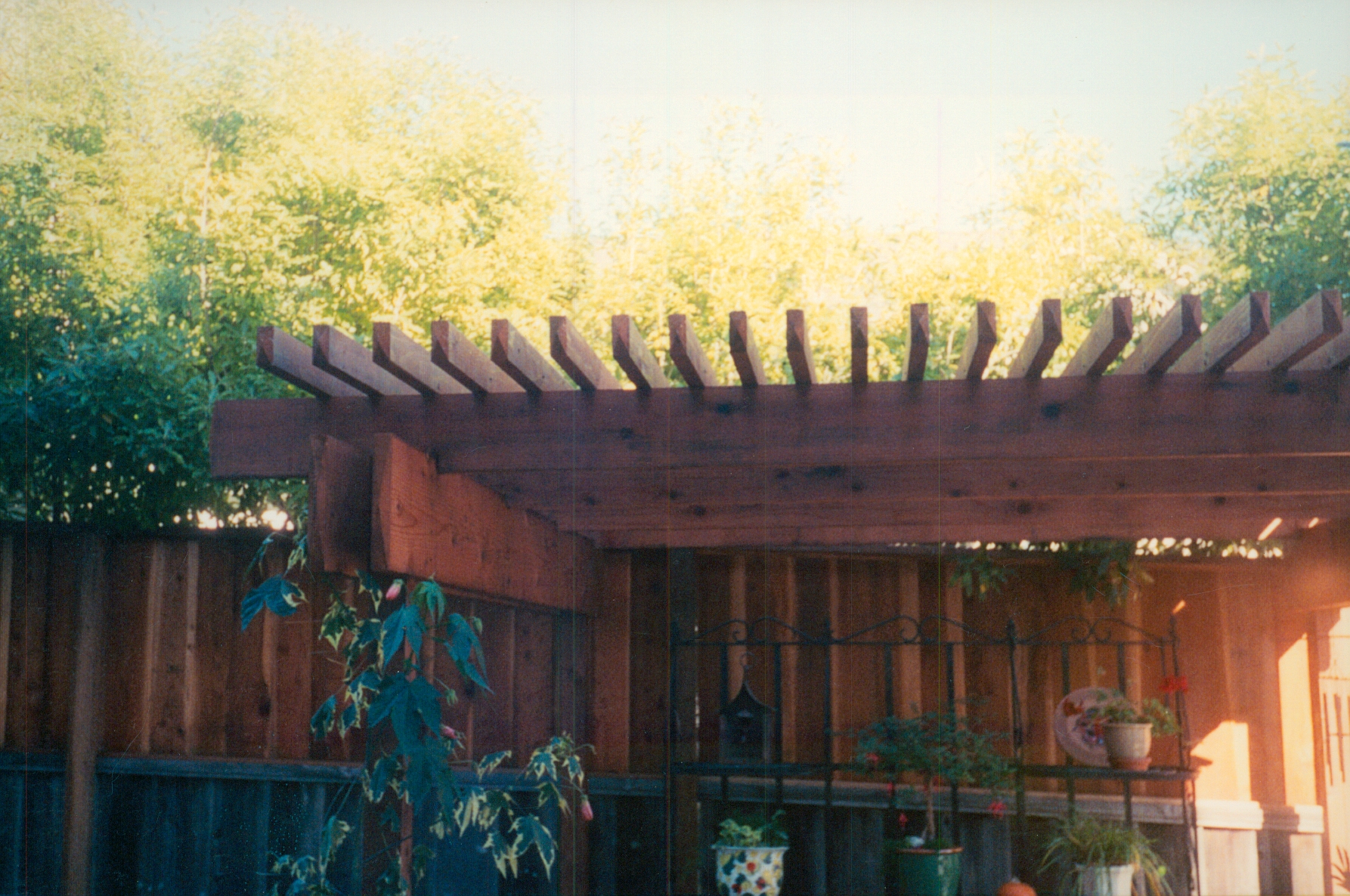 Decorative wood fence with lattice-style detailing, creating privacy while adding visual appeal to the yard.