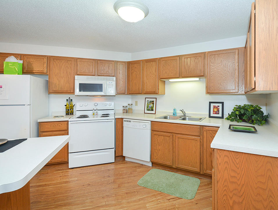Spacious Fully-Equipped Kitchen With White Appliances