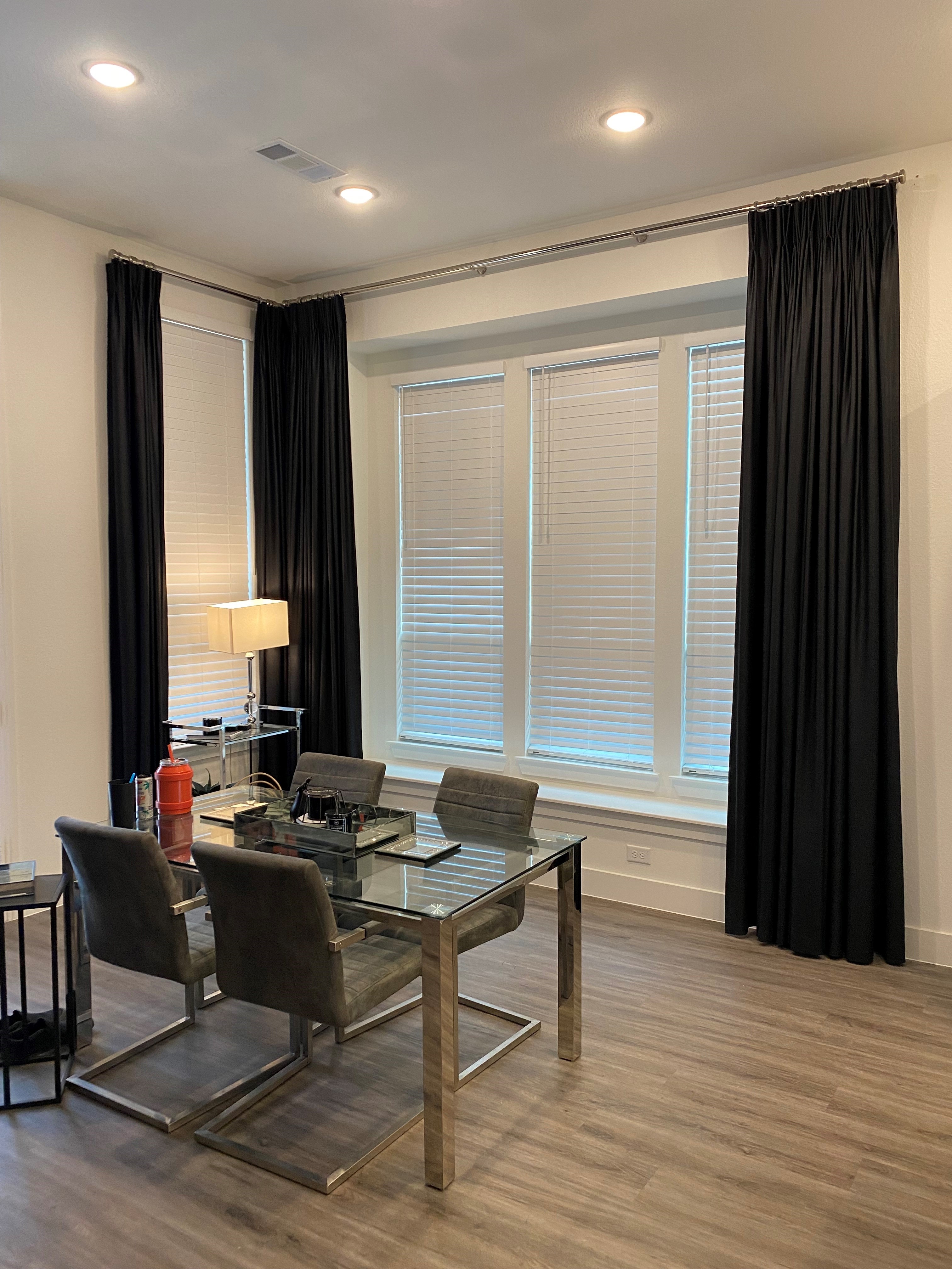 The team at Budget Blinds of Rockwall, Terrell, and Greenville absolutely love the clean, modern look of drapery paired with white faux wood blinds for you home office.