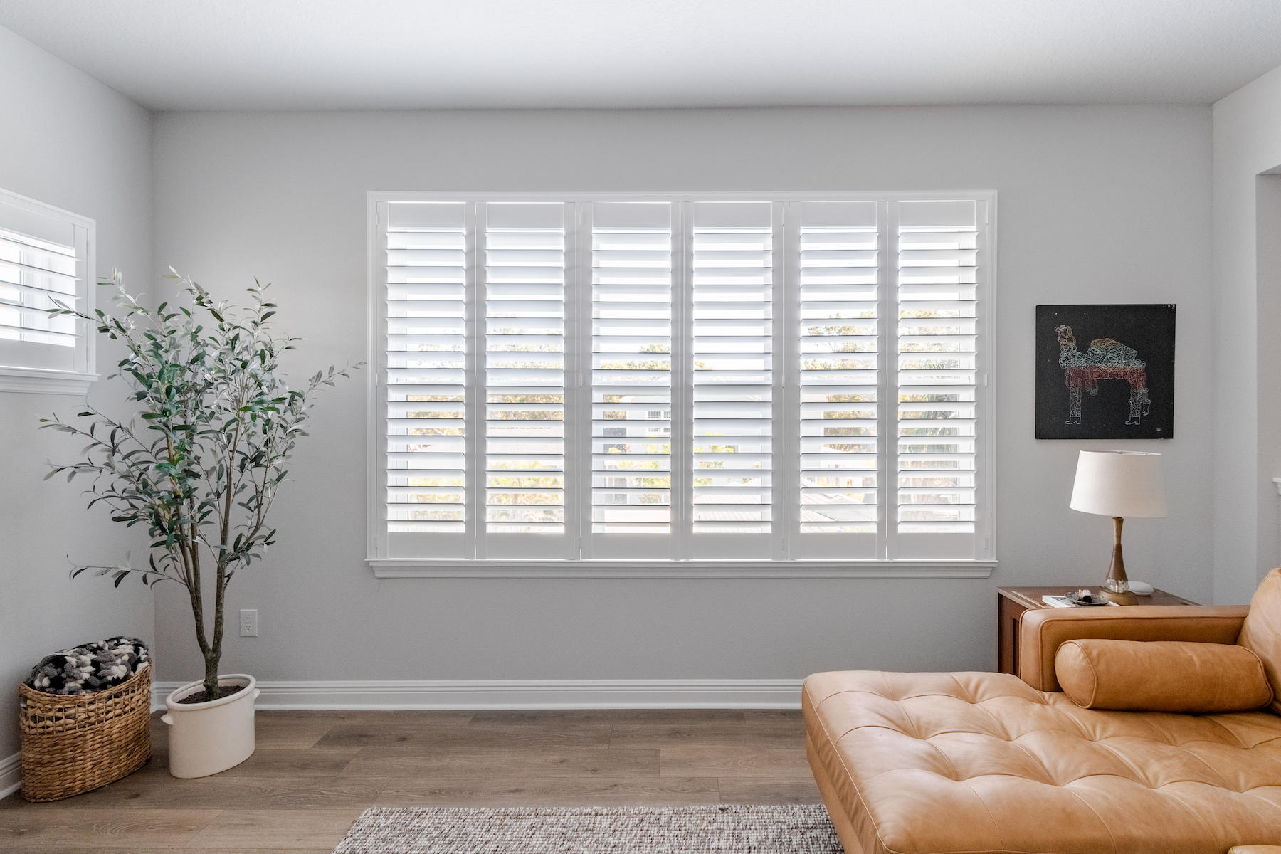 We are ready to make your living room dreams a reality! Visit our website to see all of the products that we offer. This photo shows our wood shutters and how they elevate this home.