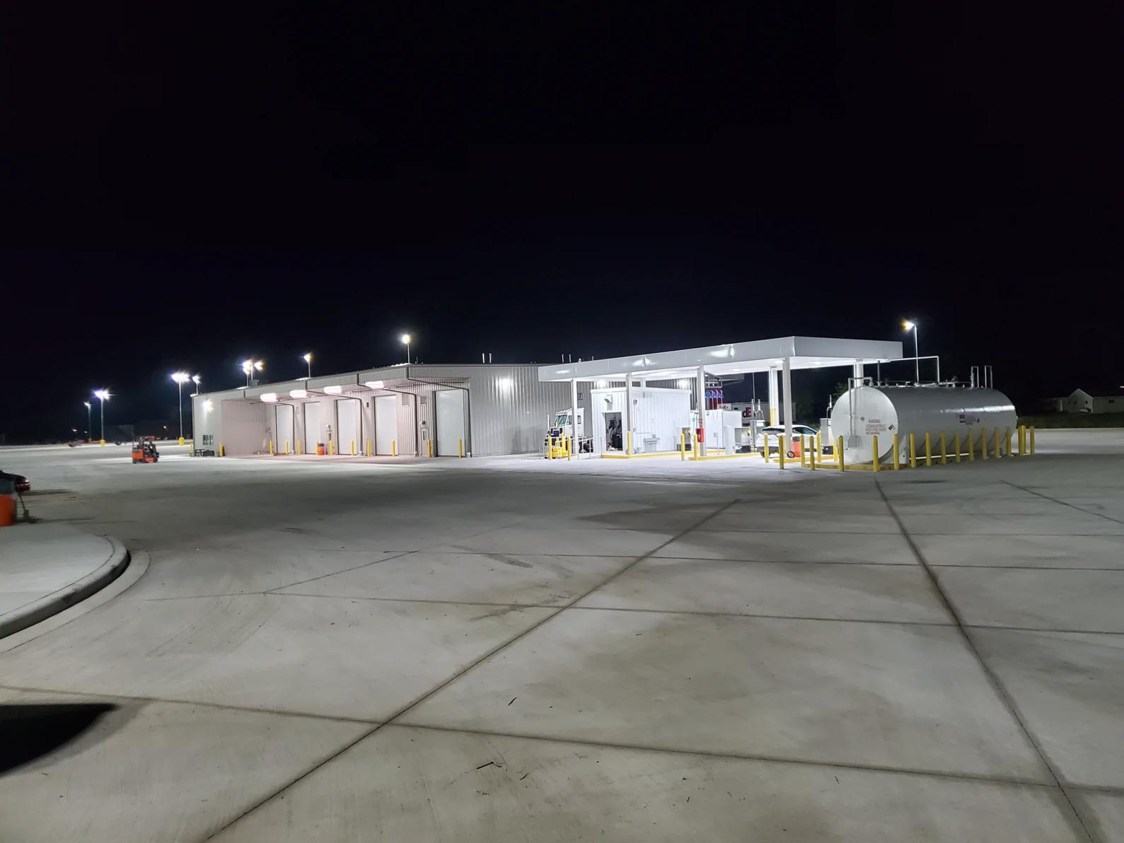 Completed commercial fuel island with storage tanks wash bays and site lighting built by industrial general contractor