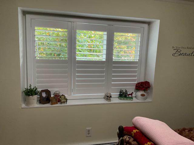 We're obsessed with these classic and romantic Plantation Shutters in this room in Ossining, NY - they evoke a timeless style that looks at home in any window! #BudgetBlindsOssining #PlantationShutters #OssiningNY #FreeConsultation