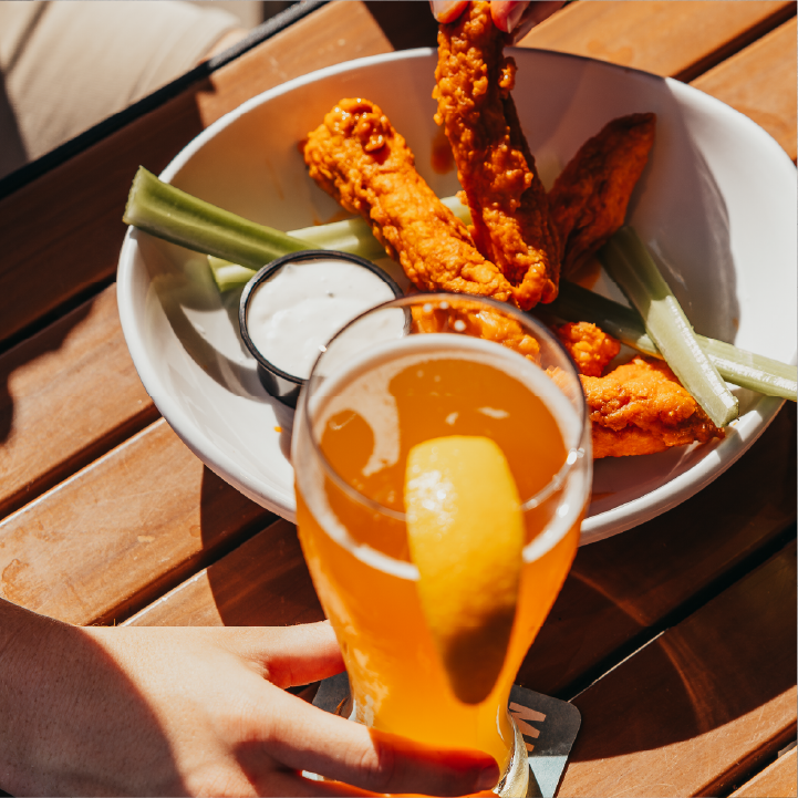 A plate of our world famous Zingers® paired with an ice cold beer served on our patio