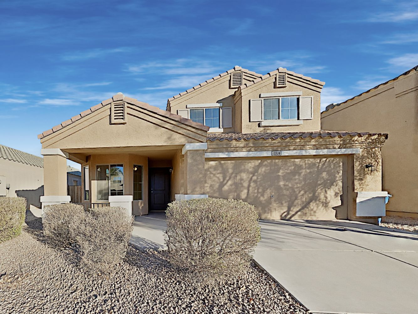 Modern desert home with covered patio and a two-car garage at Invitation Homes Phoenix.