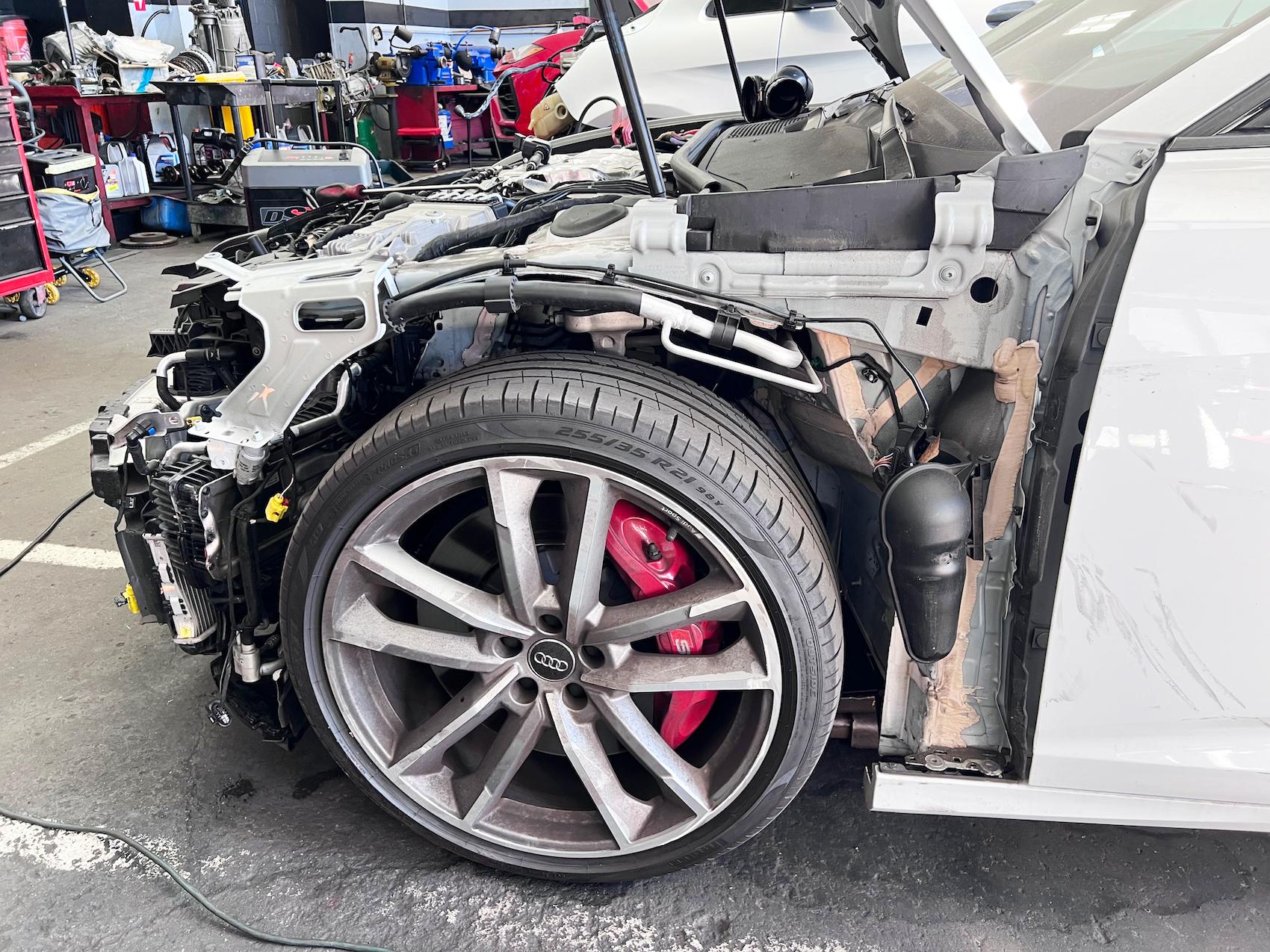 Detailed photo of Audi at auto body shop parking lot for collision repair