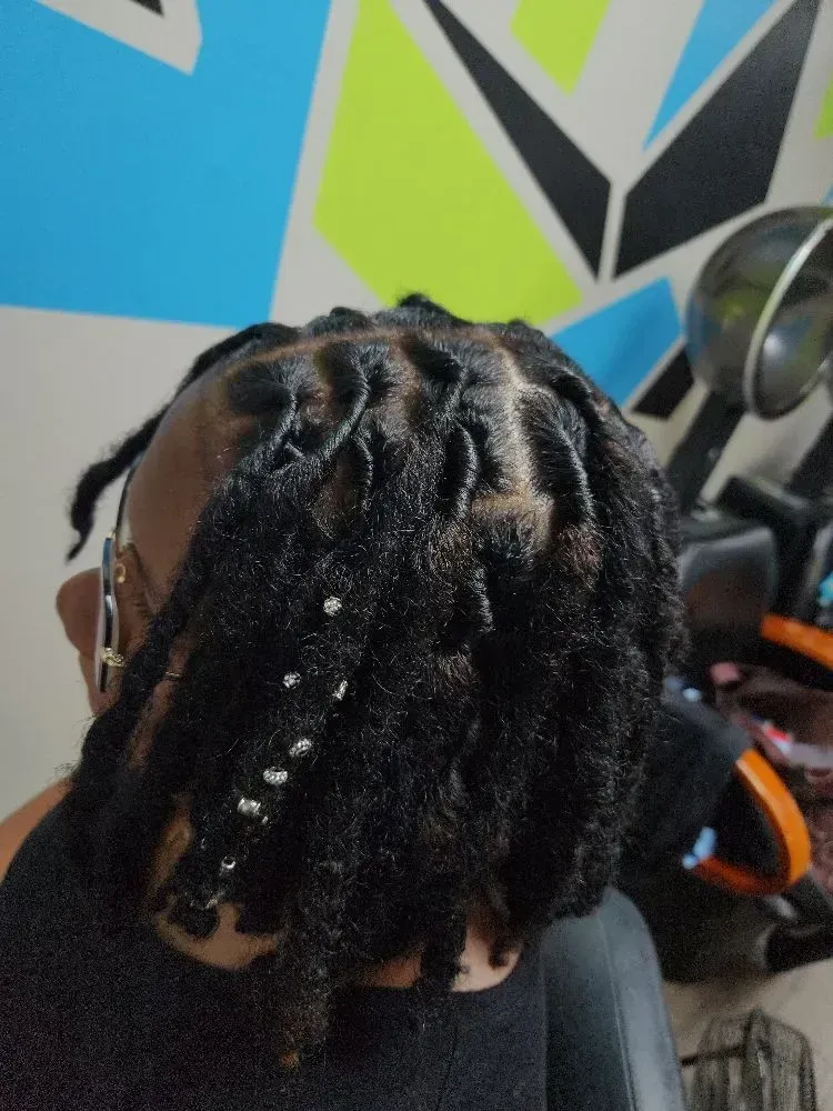 Back view of neatly maintained locs decorated with subtle beads, highlighting healthy textured hair, 